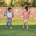 Jack and June Haven 2 Outdoor wooden playset with swing and slide, climbing ramp with rope and undercover landing. View of two children sitting on the swings