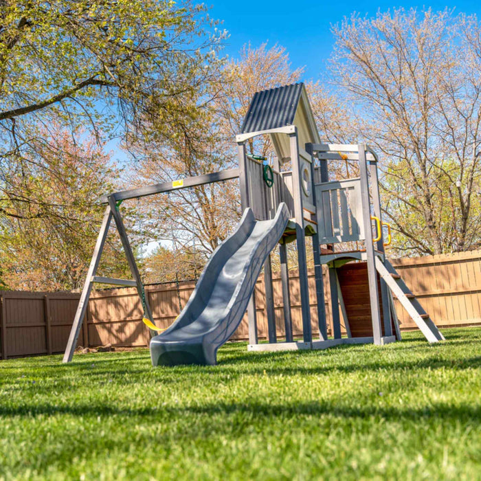 Jack and June Haven 2 Outdoor wooden playset with swing and slide, climbing ramp with rope and undercover landing. View of right front of playset in the garden