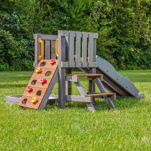 Jack and June toddler playset with climber ramp, slide and sandbox a back right view playset in the garden