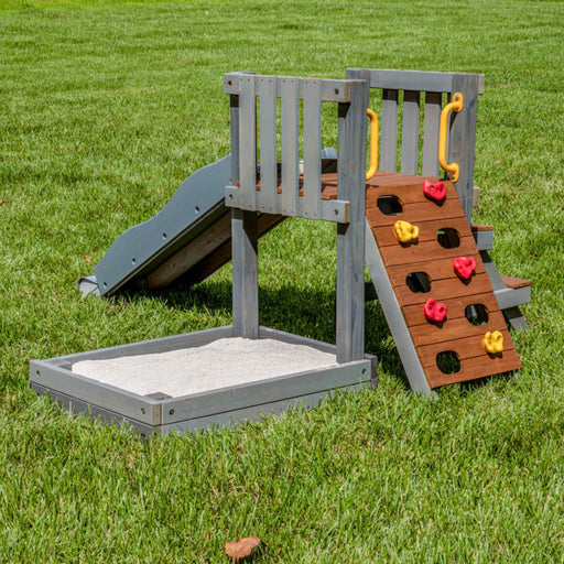 Jack and June toddler playset with climber ramp, slide and sandbox a back left view playset in the garden