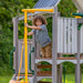 Jack and June Haven outdoor wooden playset with swings, slide, view of child holding onto the fire man's pole 